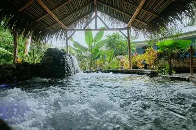 a plunge pool in a resort with a waterfall at Oasis Diverse Adult Retreat in Quepos