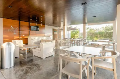a restaurant with white tables and white chairs at New & Modern APT - 100 MBPS 15 min from airport in San José