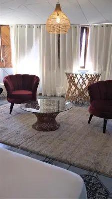 a living room with two chairs and a coffee table at Space One in Manuel Antonio