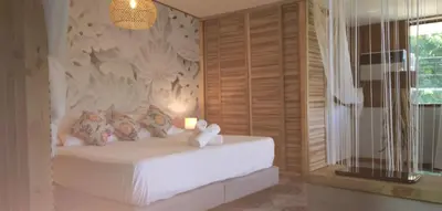 a bedroom with a bed with a candle and a window at Space One in Manuel Antonio