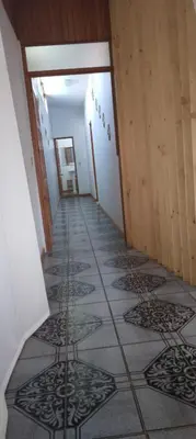 a hallway with a tile floor in a house at Space One in Manuel Antonio