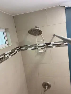 a bathroom with a shower with a shower head at Green House by W. in Heredia