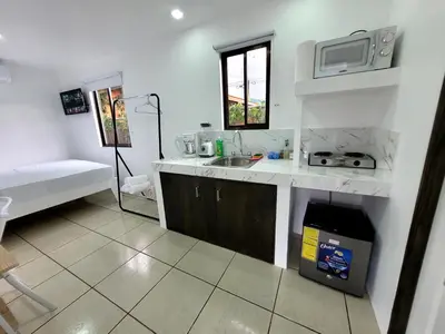 a kitchen with a sink and a microwave at La Fonda Apartments in Fortuna