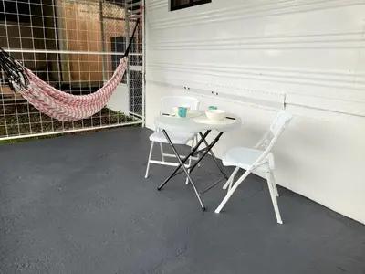 a white table and two chairs and a hammock at La Fonda Apartments in Fortuna