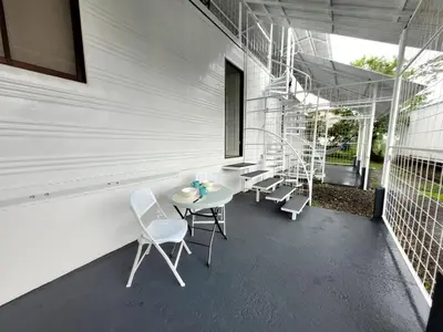 a patio with a table and chairs on a building at La Fonda Apartments in Fortuna