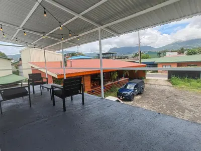 a patio with a table and a car parked on it at La Fonda Apartments in Fortuna