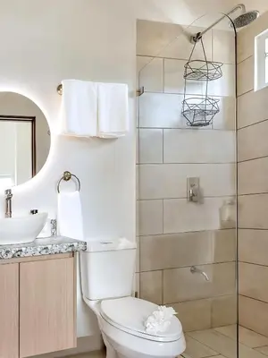 a bathroom with a toilet and a sink and a shower at Modern 2BR Condo - minutes from Jaco Beach - PRIME location in Jacó