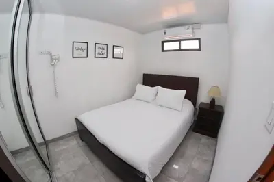 a small bedroom with a bed and a shower at Airport SJO Residence Cars4Rent 
