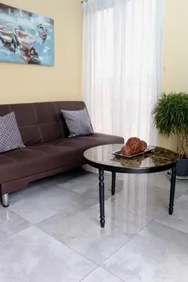 a living room with a couch and a coffee table at Airport SJO Residence Cars4Rent 