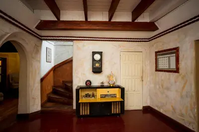 a room with a door and a clock on the wall at Casa de Piedra Escazú in San José