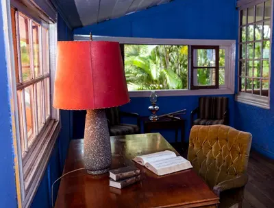 a lamp on a table in a room with blue walls at Casa de Piedra Escazú in San José