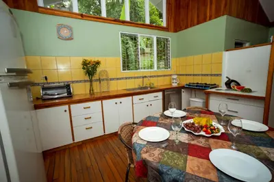 a kitchen with a table with a plate of food on it at Casa de Piedra Escazú in San José