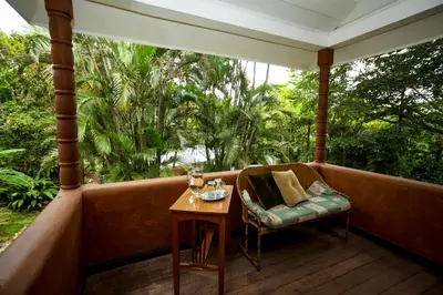 a porch with a table and a chair at Casa de Piedra Escazú in San José
