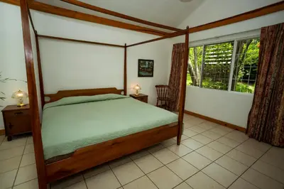 a bedroom with a canopy bed and a window at Casa de Piedra Escazú in San José