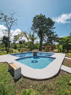 a swimming pool in the middle of a yard at Cabañas Don Ramiro in Colonia Dos Ríos