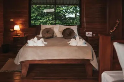 a bedroom with a bed with towels on it at Cabañas Don Ramiro in Colonia Dos Ríos