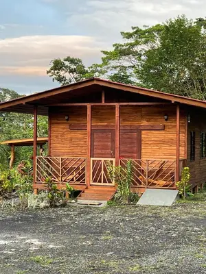 a wooden cabin with two doors and a porch at Cabañas Don Ramiro in Colonia Dos Ríos