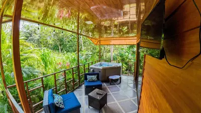 an inside view of a tree house with a balcony at Bungalows Las Iguanas Arenal Volcano in Fortuna
