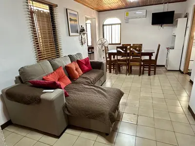 a living room with a couch and a table at Apartment 10 minutes by the SJO airport - in Alajuela City