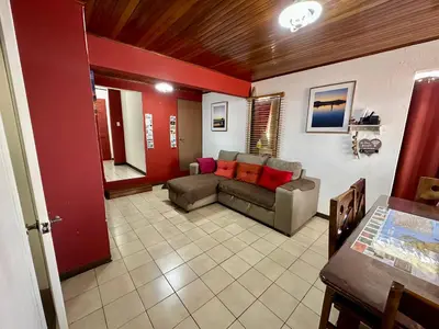 a living room with a couch and a table at Apartment 10 minutes by the SJO airport - in Alajuela City