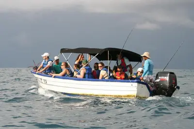 a group of people in a boat in the water at Cabinas surf Arribadas in Playa Ostional