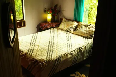 a bedroom with a bed and a window at Casa Alquimia in Monteverde Costa Rica