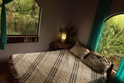 a bedroom with a bed and a window at Casa Alquimia in Monteverde Costa Rica