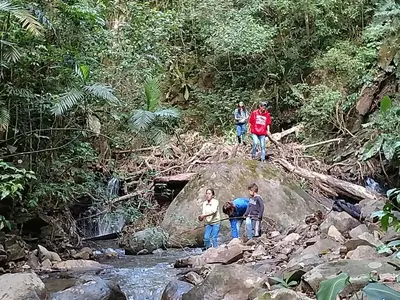 a group of people standing on a rock in a river at Casa Alquimia in Monteverde Costa Rica