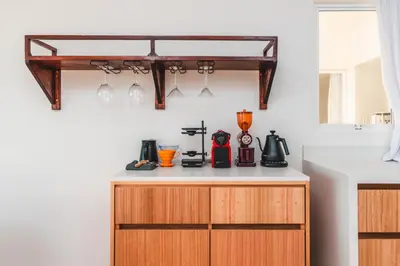 a kitchen with a counter with a shelf on the wall at Buena Vista Ocean View Apartments Santa Teresa in Santa Teresa Beach