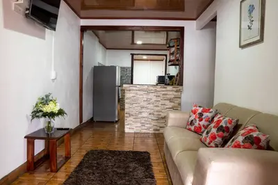 a living room with a couch and a kitchen at Tony's House in Fortuna