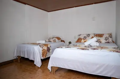 two beds sitting next to each other in a room at Tony's House in Fortuna