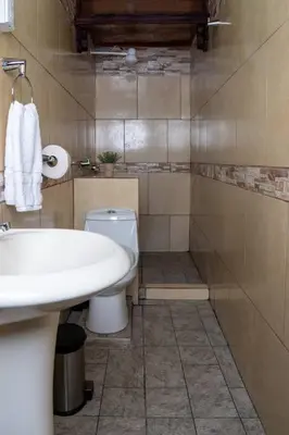 a bathroom with a sink and a toilet at Tony's House in Fortuna