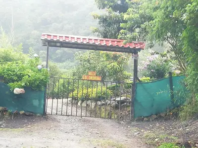 a gate to a garden with a sign on it at Villa Golondrina Cabaña rodeada de Naturaleza in Monteverde Costa Rica