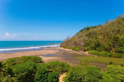 an aerial view of a beach and the ocean at Break Water Point Penthouse 7th Floor in Jacó