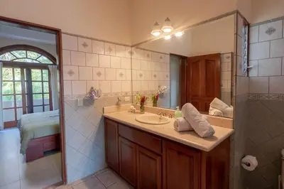 a bathroom with a sink and a mirror at Casa Sol in Herradura