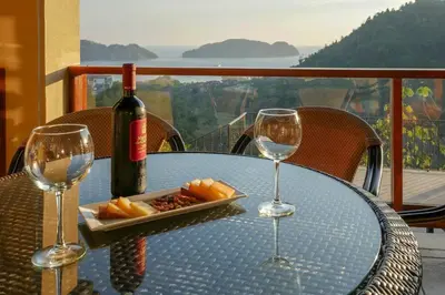 a table with a bottle of wine and two glasses at Casa Sol in Herradura