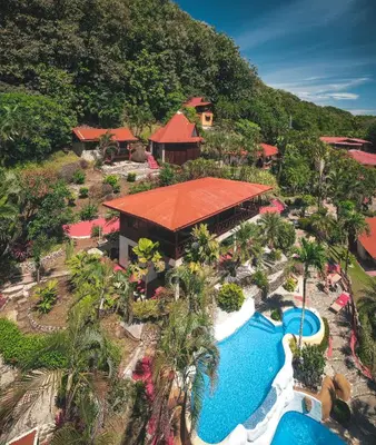 an aerial view of a resort with a swimming pool at Hotel El Jardin in Montezuma