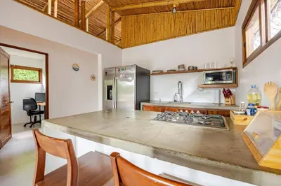 a kitchen with a large counter top in a room at Villa Fruta del Cielo in Uvita