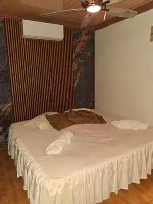 a bedroom with a large white bed with a ceiling at Garden House in Fortuna