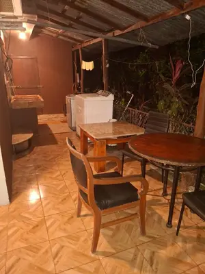 a dining room with two tables and a piano at Garden House in Fortuna