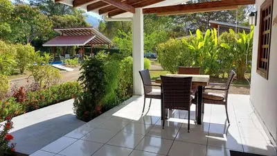 a porch with a table and chairs on a patio at Casa Hibiscus in Ojochal