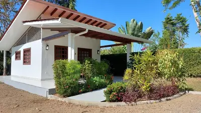 a small white house with a roof at Casa Hibiscus in Ojochal