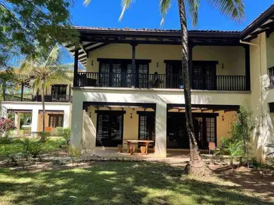 a house with a picnic table in front of it at 3 Bedroom Villa in Hacienda Pinilla in Tamarindo