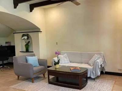 a living room with a couch and a chair and a table at 3 Bedroom Villa in Hacienda Pinilla in Tamarindo