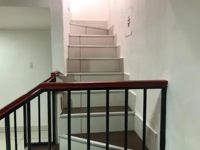 a stairway with white stairs in a building at Pinky’s Place Airport, Full Equipment. in Alajuela City
