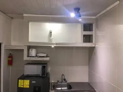 a small kitchen with a sink and a microwave at Pinky’s Place Airport, Full Equipment. in Alajuela City