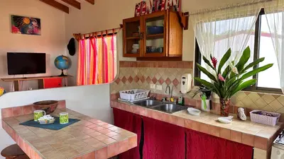 a kitchen with a sink and a counter top at The Inner Light Yoga Lodge in Sámara