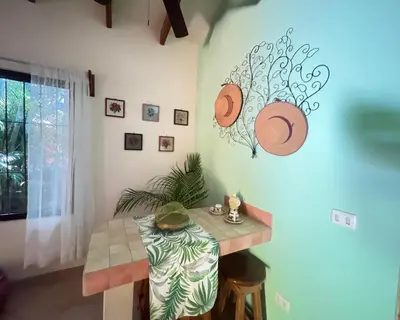 a dining room with a table and a plate on the wall at The Inner Light Yoga Lodge in Sámara