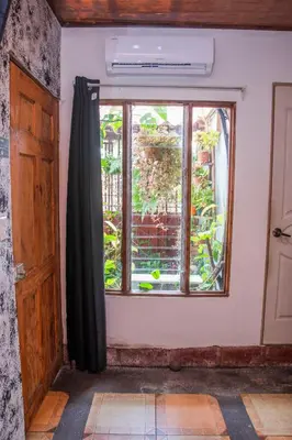 an empty room with a window and a door at Gardens House, Airport Juan Santamaría, Alajuela, San José in Alajuela City