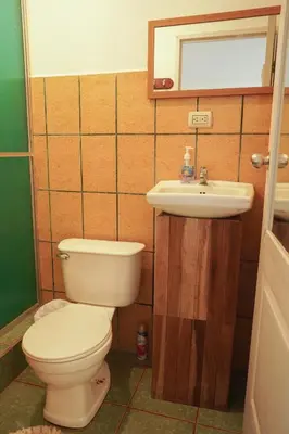 a bathroom with a toilet and a sink at GALA Santa Teresa Apartments 80m from the Beach in Santa Teresa Beach